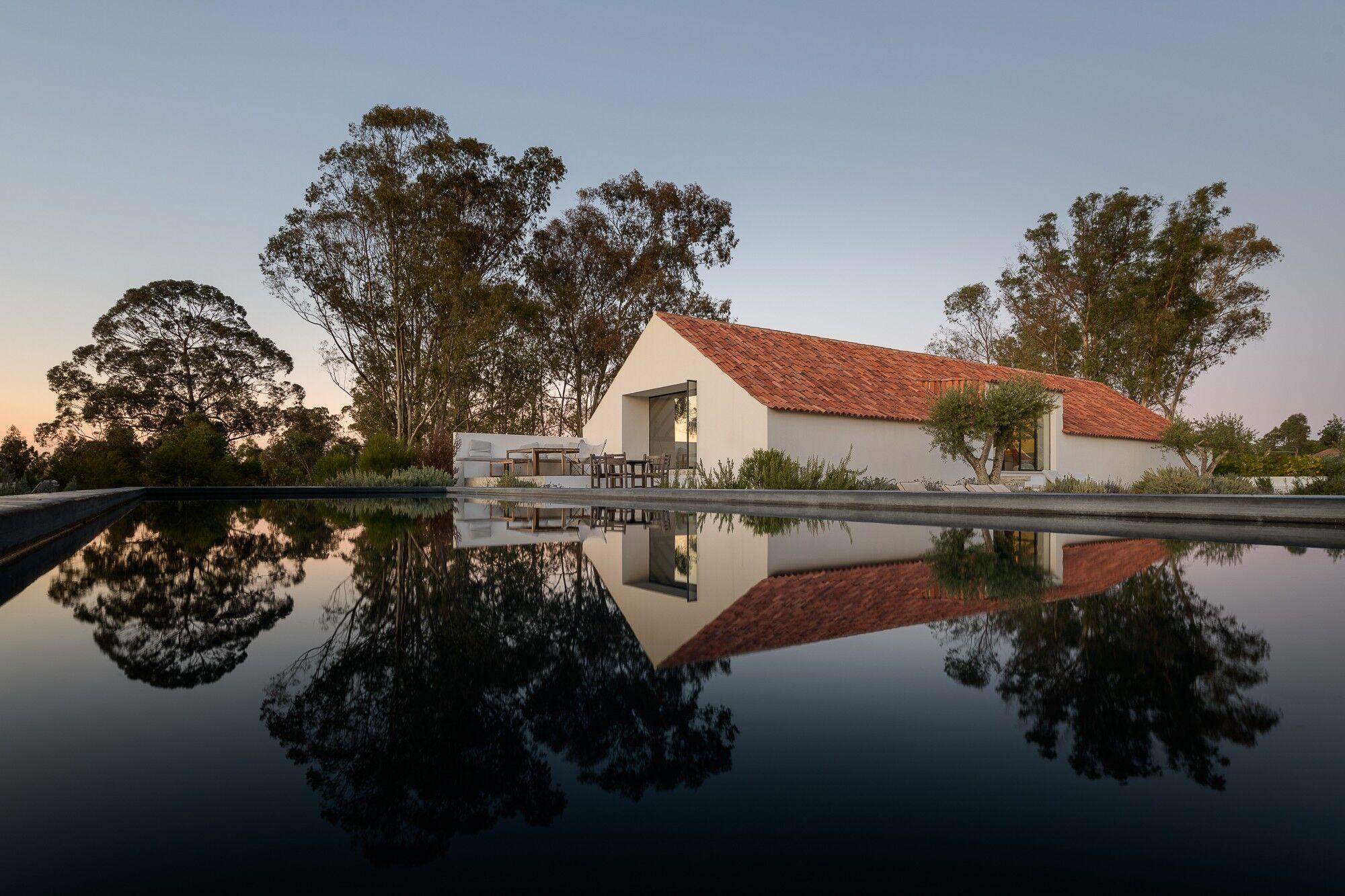 The Portugal 2027 retreat venue and reflecting pool at sunset